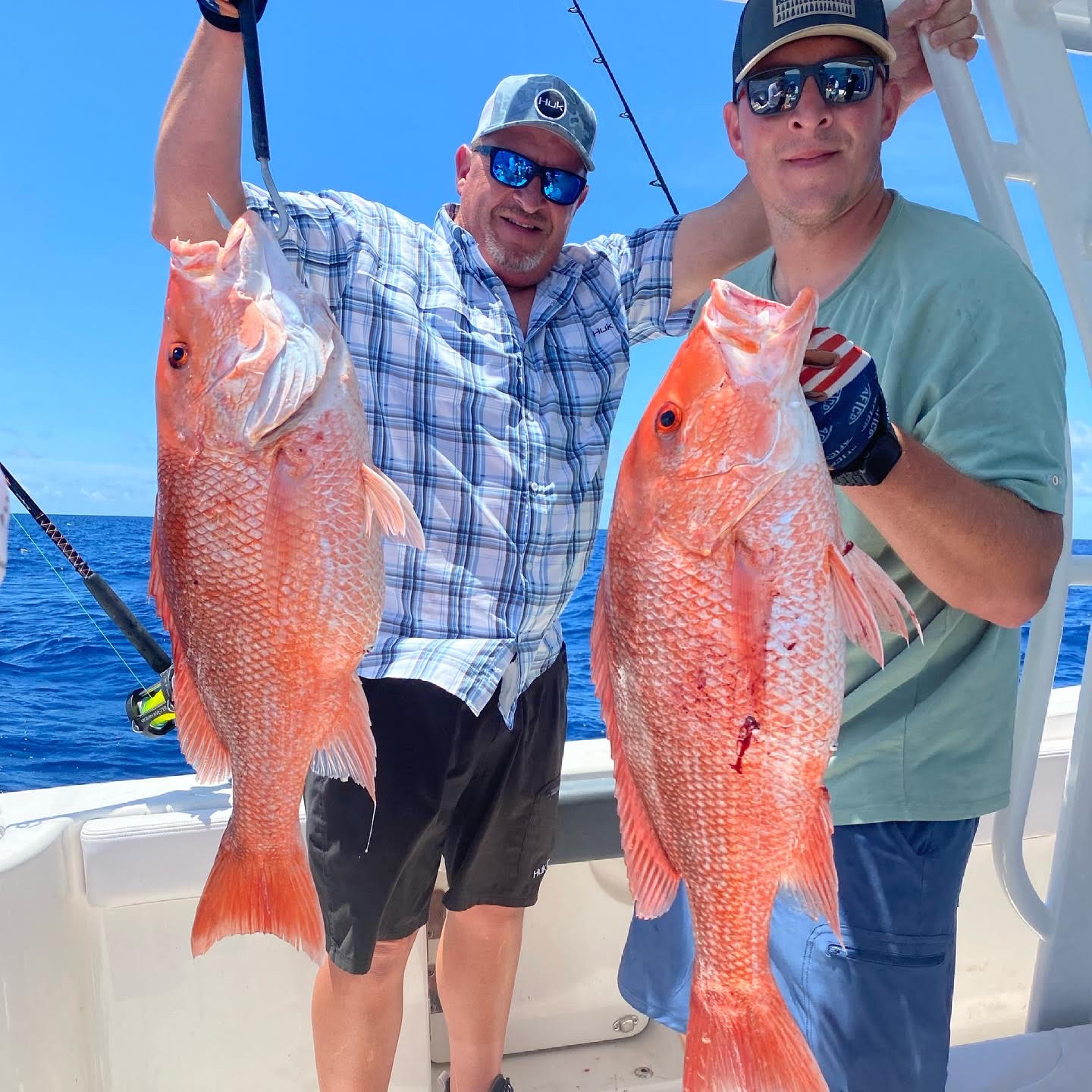 holding their newly caught red snapper